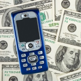 Mobile phone on money background